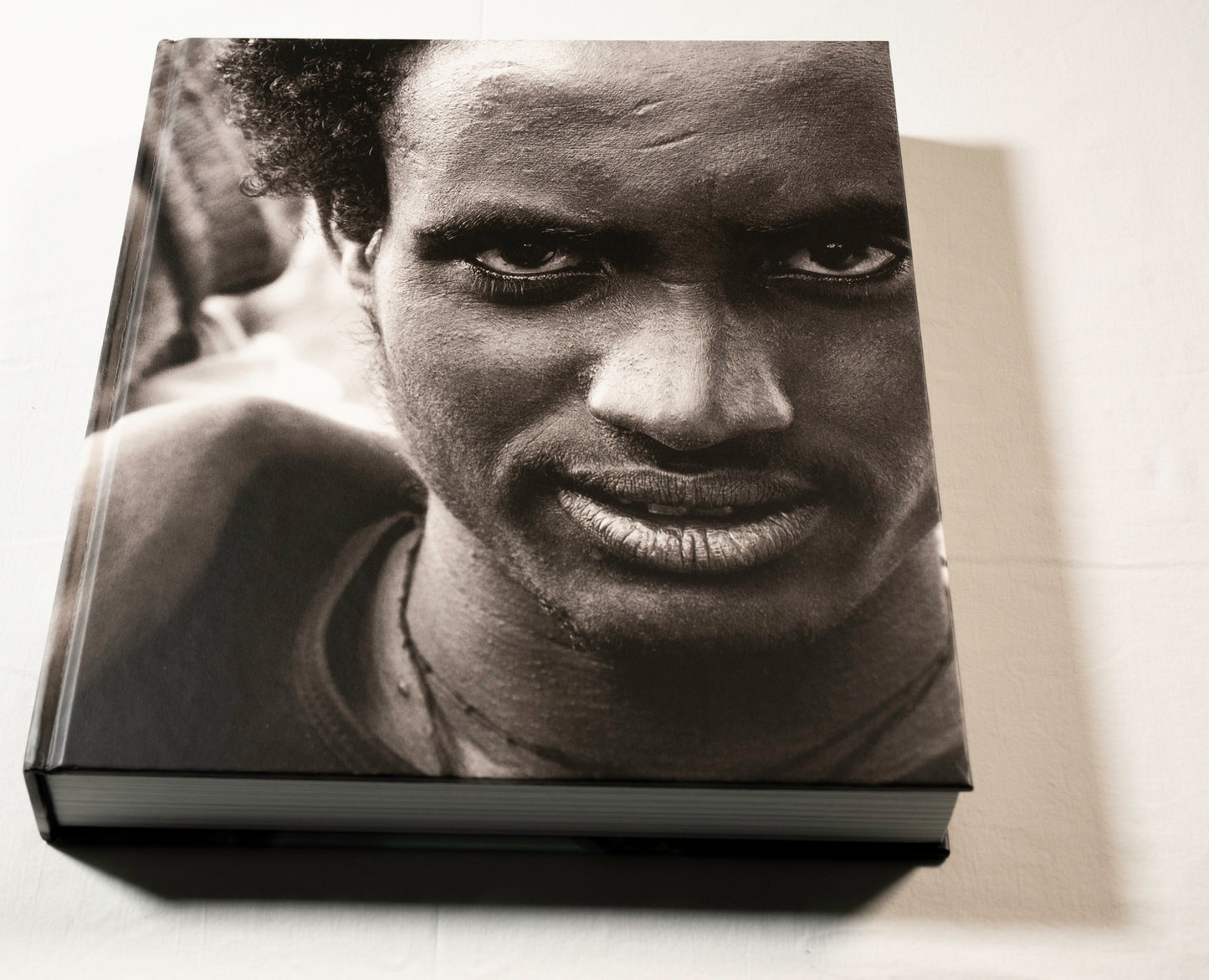 "Stories Untold" cover with a black and white photo of a person's face on a light background.