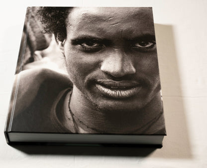 "Stories Untold" cover with a black and white photo of a person's face on a light background.