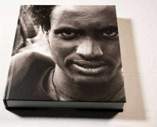 "Stories Untold" cover with a black and white photo of a person's face on a light background.